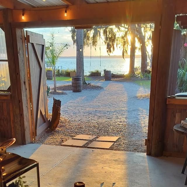 Waterfront event venue at sunset, viewed through the barn doors